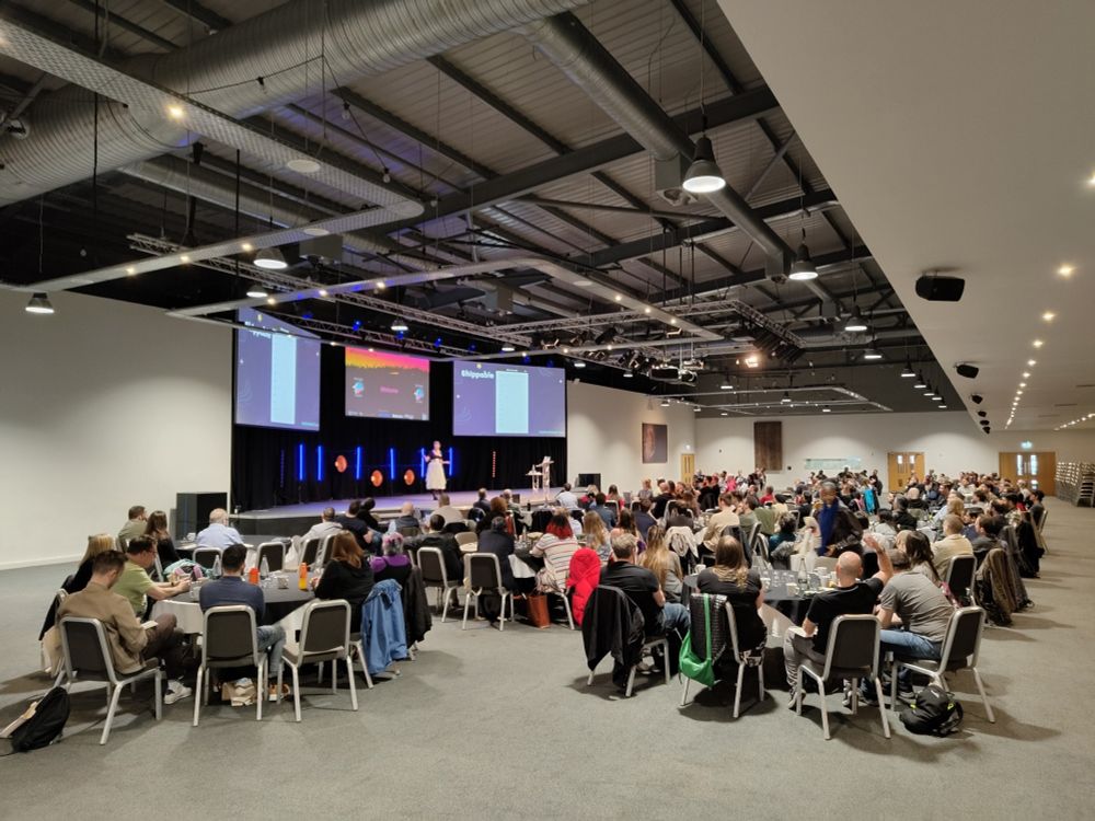 View of the Testing Peers stage at Trent Conference Centre.  Delegates arranged in cabaret style taking in the keynote delivered by Heather Reid.