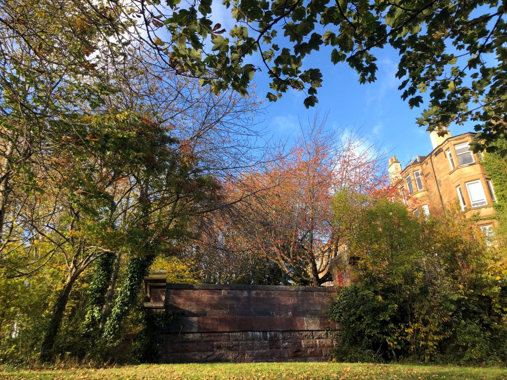 Parapet with autumn trees and blue sky