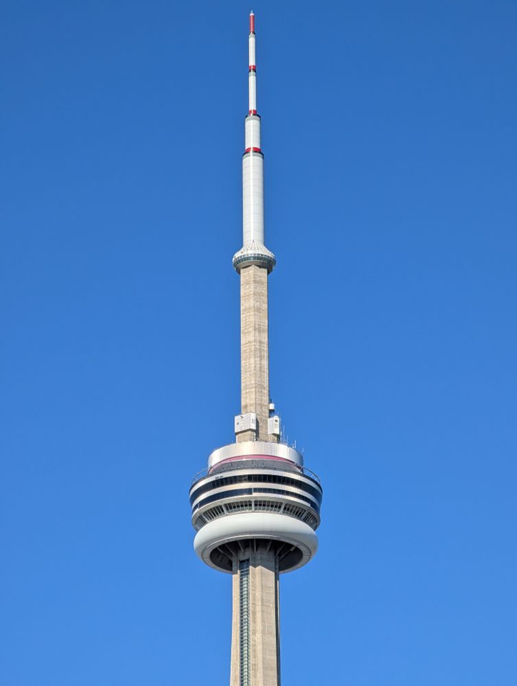 Top of the CN tower against a perfect blue sky