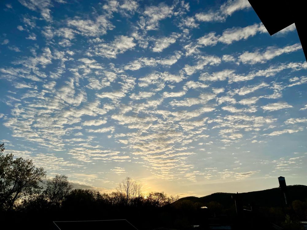 Sky full of dotted clouds as the sun rises