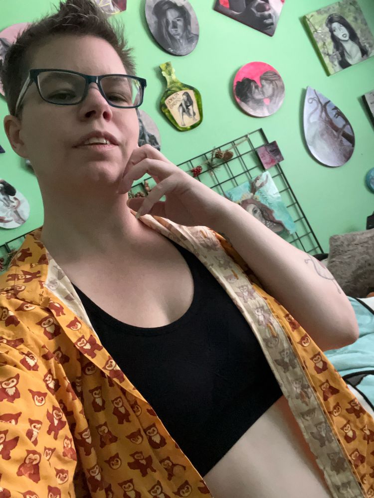 Masc enby in an open shirt and crop