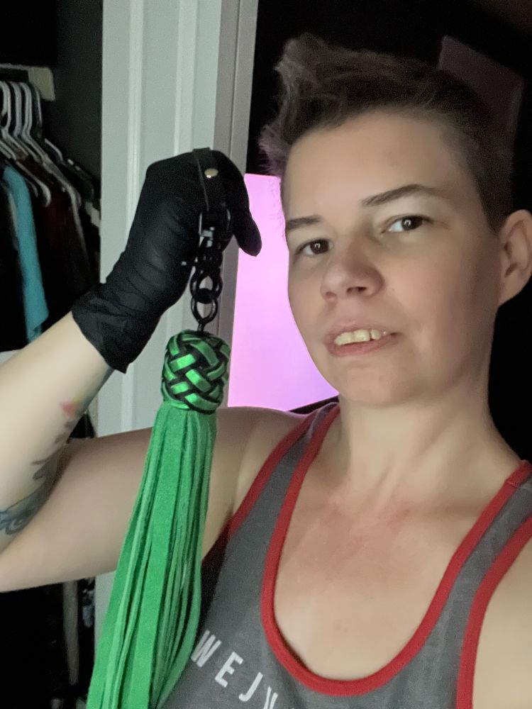 Selfie with flogger and black latex gloves