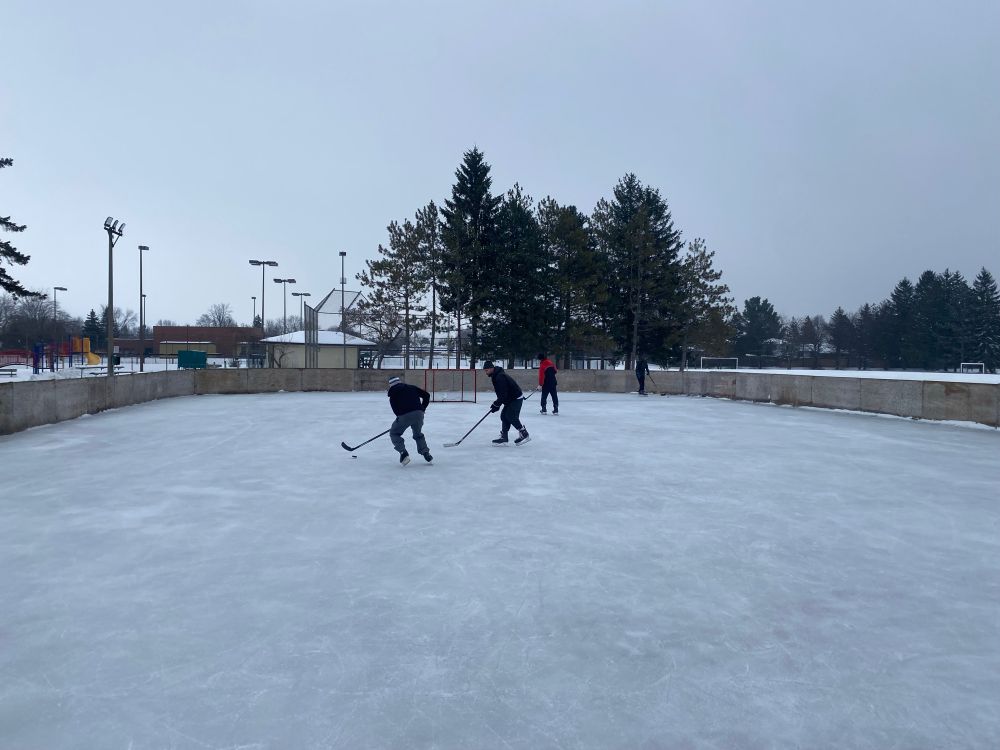Guys playing hockey on an outdoor rink in Ottawa Canada 