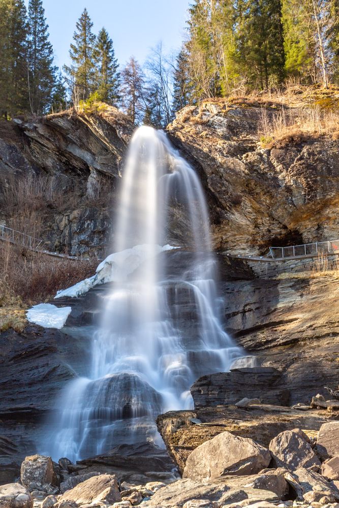 Long exposure photo of a waterfall creating blurred streaks out of the moving water.
