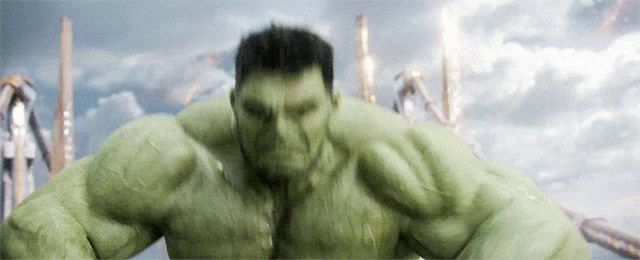 a close up of a hulk 's face with a cloudy sky in the background