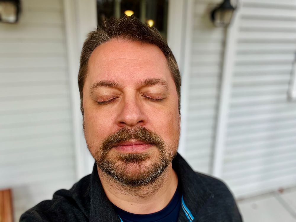 Exactly the same picture as the previous one—me, in front of a house—but in this one my eyes are closed.