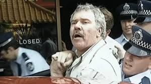Image of an Australian man getting arrested, known as the Democracy Manifest meme.