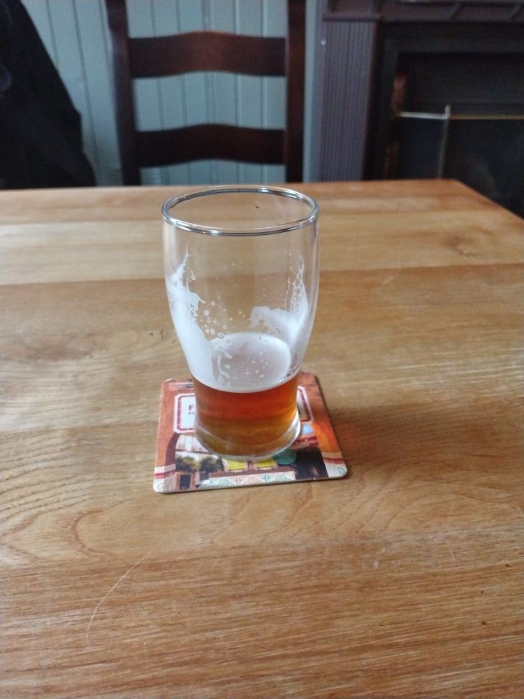A half of Pennine Amber Nectar beer 