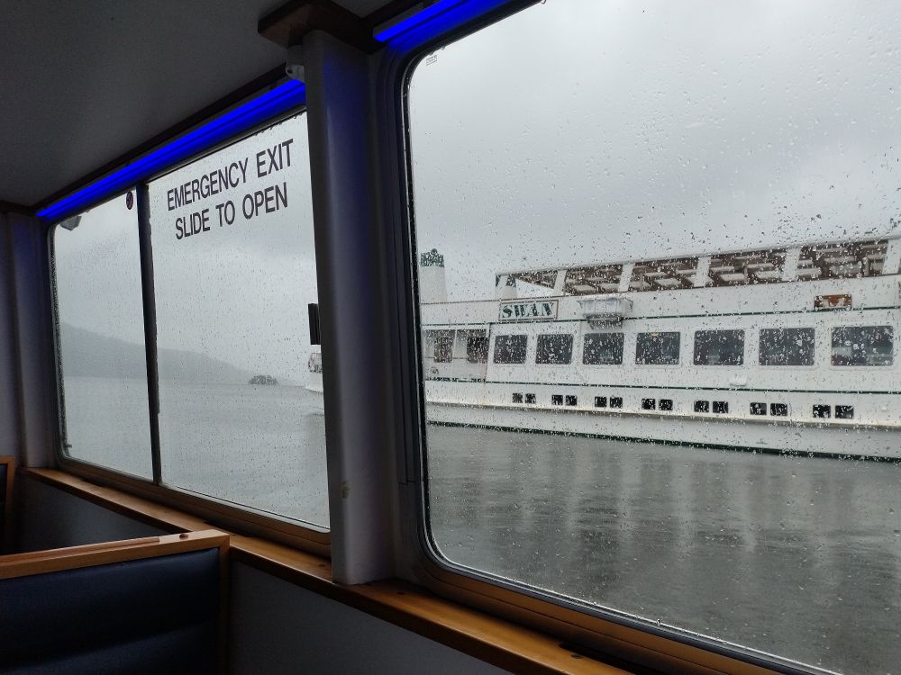 Catching a boat from Bowness to Ambleside on a very wet day.