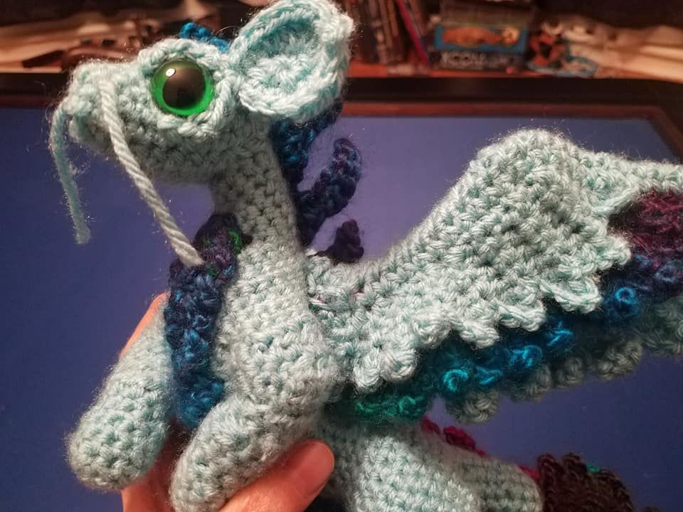 a crocheted blue dragon