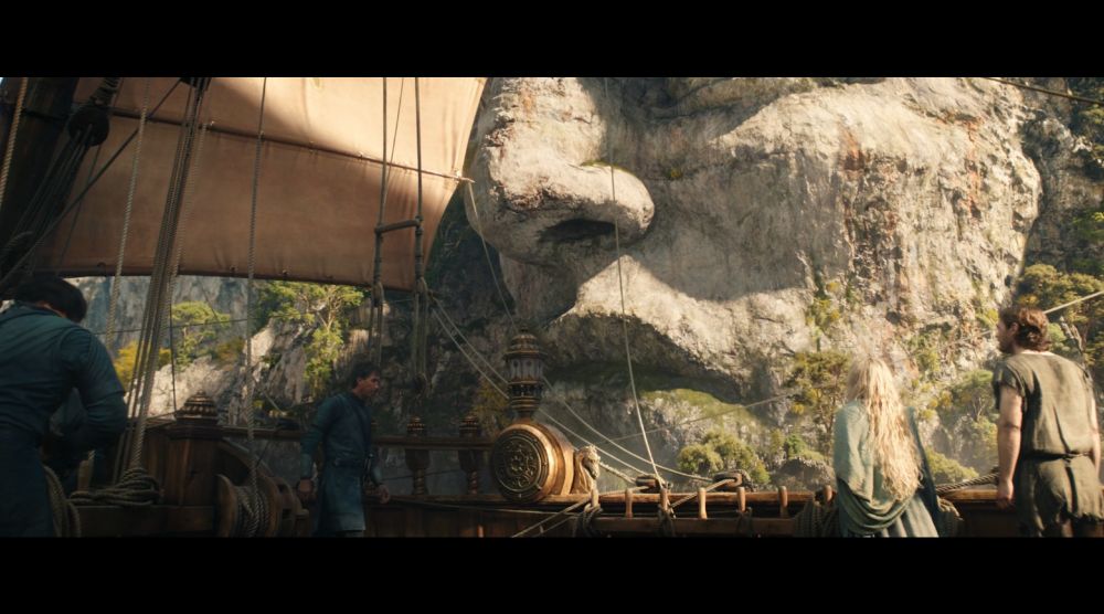 from season 1 episode 3 of the rings of a power, the numenorean ship sails past a giant statue head of an ancient king.