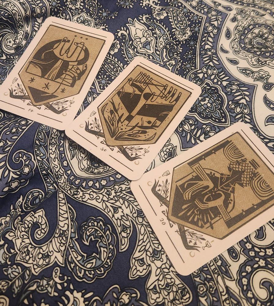3 divination cards displayed on a bedspread
