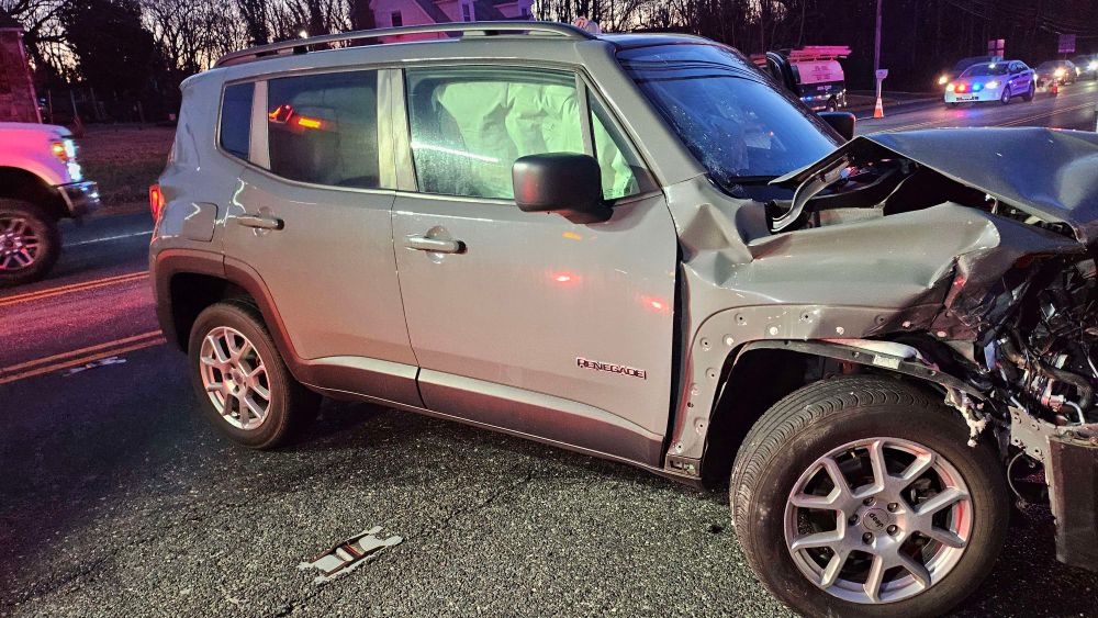 The side of the car, where airbags can be seen having been deployed and some of the damage can be seen of the front