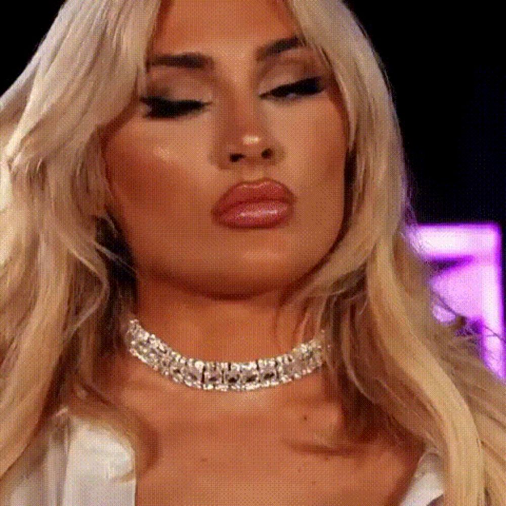 a close up of a woman wearing a choker and earrings .