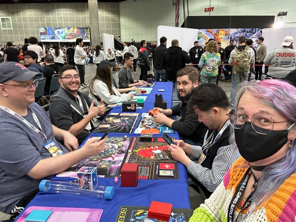 A selfie of a 3v3 Digimon tcg game between me, my team mates Hung, and Kris, an unseen player, Ivan, Joe, and Idan.