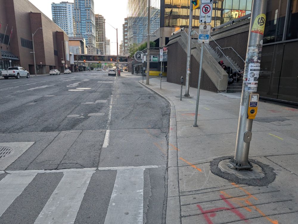 Photo of King Street with side walking reducing in width, toward the Jackson Square parking garage.