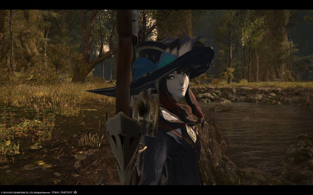 Final Fantasy 14 screenshot of the big hatted player character looking at the camera in the woods