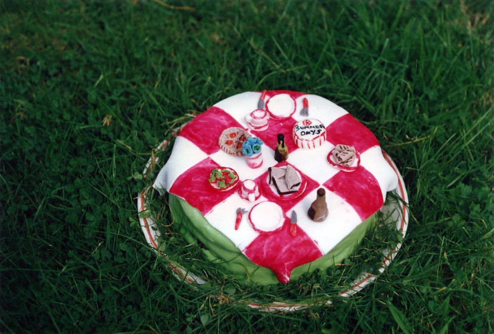A photo of a birthday cake made to look. Like a picnic