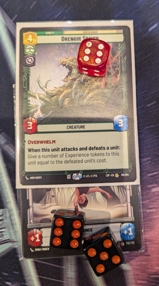 The card Dengar Spawn from the Legends of the Force set of Star Wars Unlimited.  It has six damage marked on it and eleven experience tokens on it, indicated by one experience token card with two dice on it showing a five and a six to indicate eleven tokens.