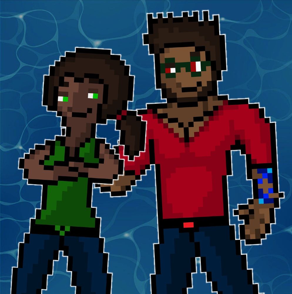 Priya & Aaron playfully staring at each other while the former’s arms are crossed and the latter’s arm is on her back.