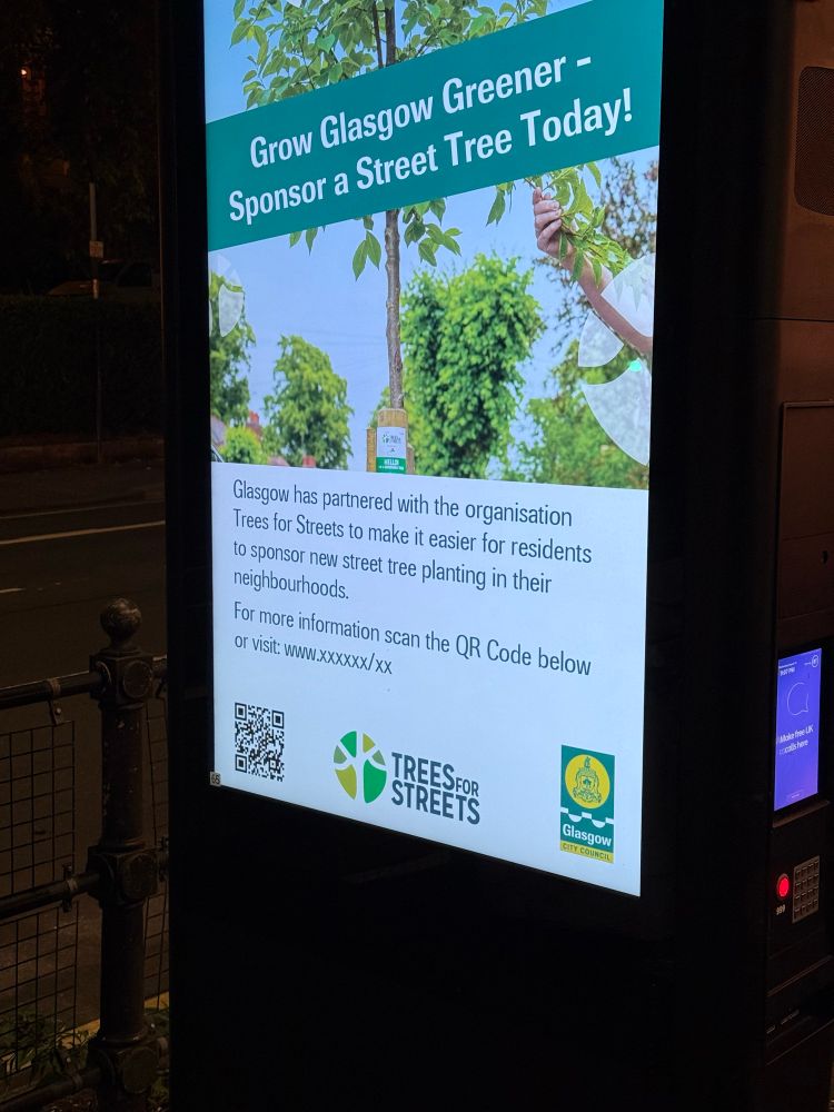 On a digital ad board: “Grow Glasgow Greener — Sponsor a Street Tree today! […] For more information scan the QR Code below or visit: www.xxxxxx/xx” (The QR code does actually point to a real page on Glasgow City Council’s website)