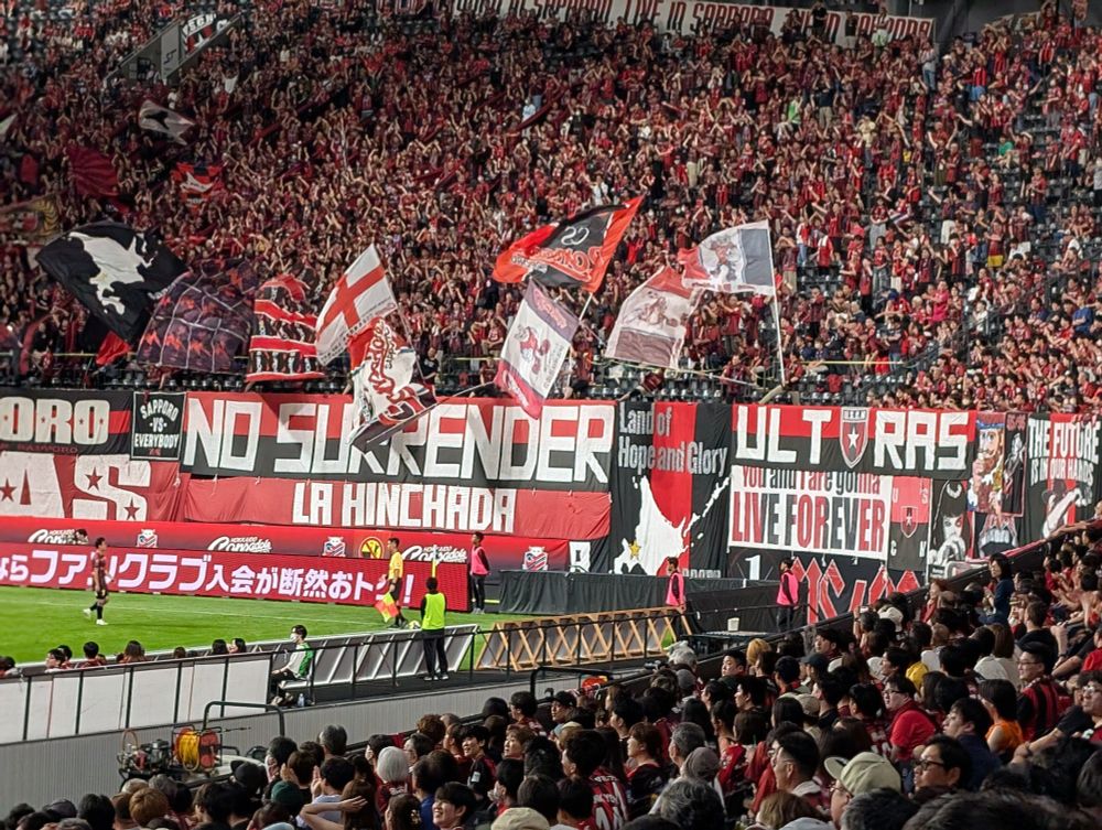 Soccer banners including "No surrender/La hinchada", "Land of Hope and Glory", and "You and I are gonna live forever"