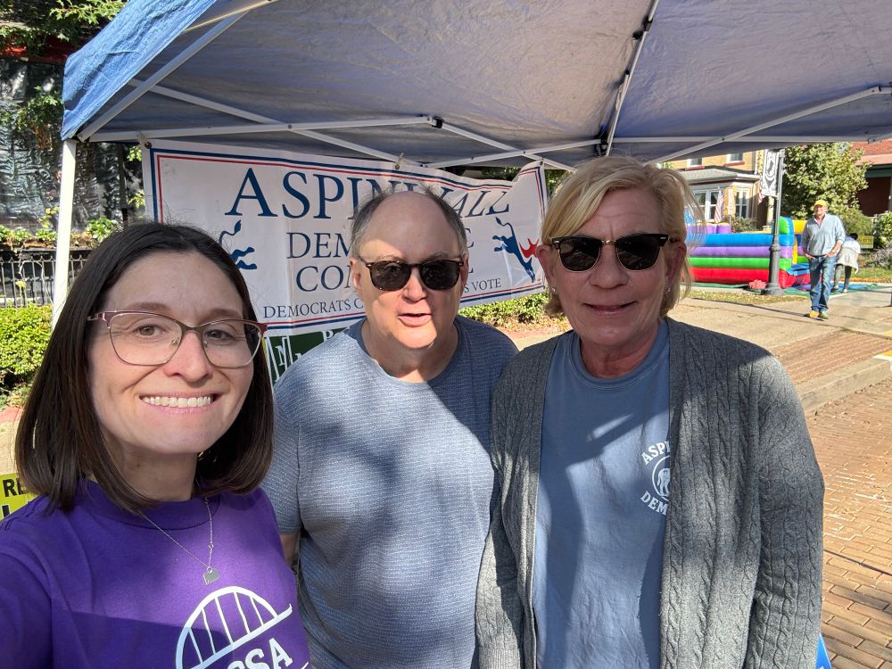Lissa wearing a purple campaign tshirt with members of the Aspinwall democratic committee.