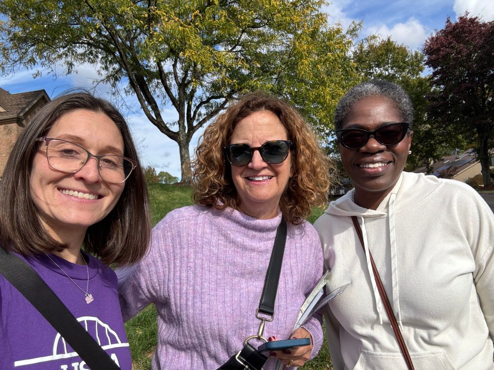 Lissa wearing a purple campaign T-shirt pictured on a suburban street with two other women; one is Ohara Councilmember Olivia Payne.