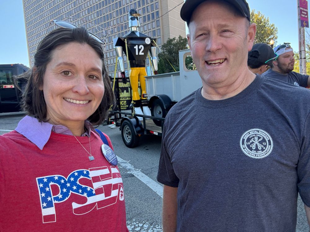 Lissa with the float and Mike Shields of Sheetmetal Local 12 and their float in the background.