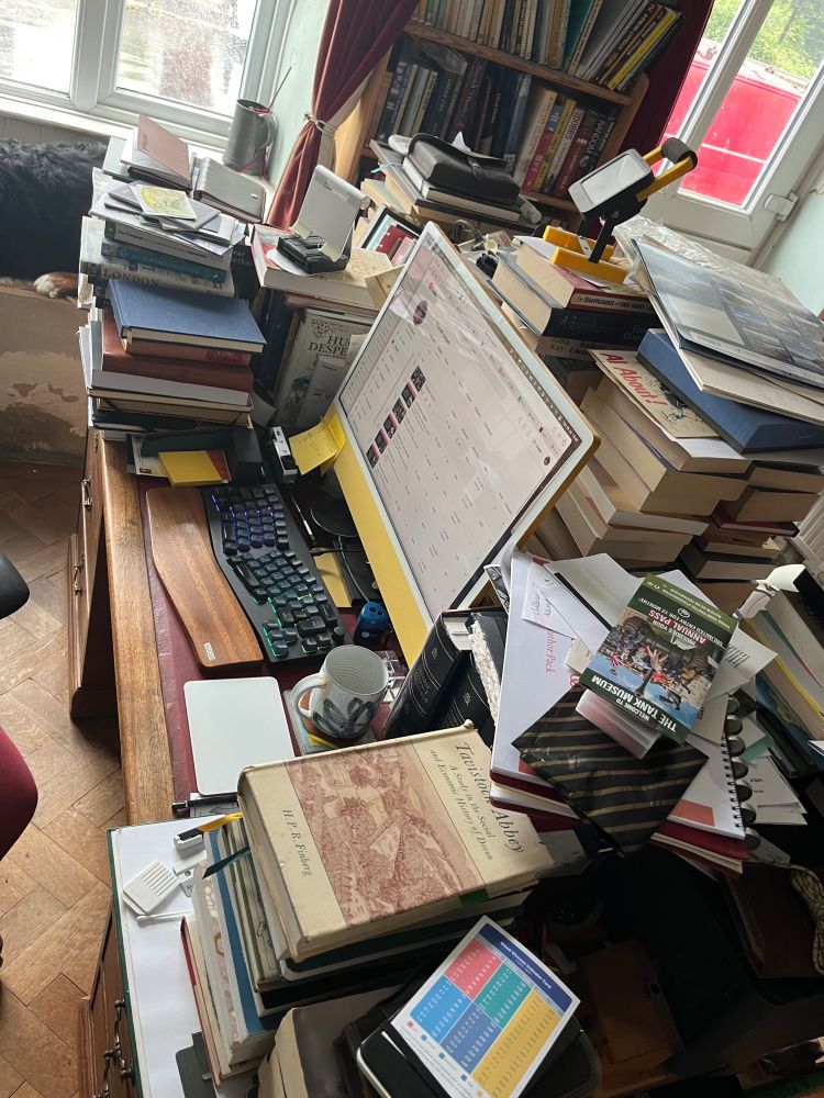 My desk smothered in research books!