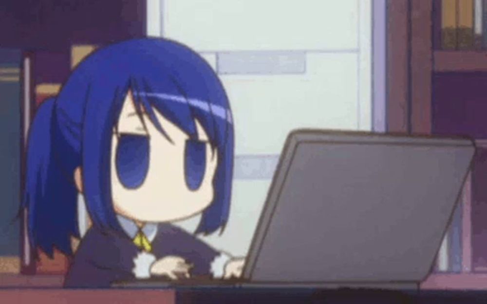 a little girl with blue hair is sitting at a desk using a laptop computer .