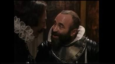 Iago-actor wearing Shakespearean dress with white ruff around neck.