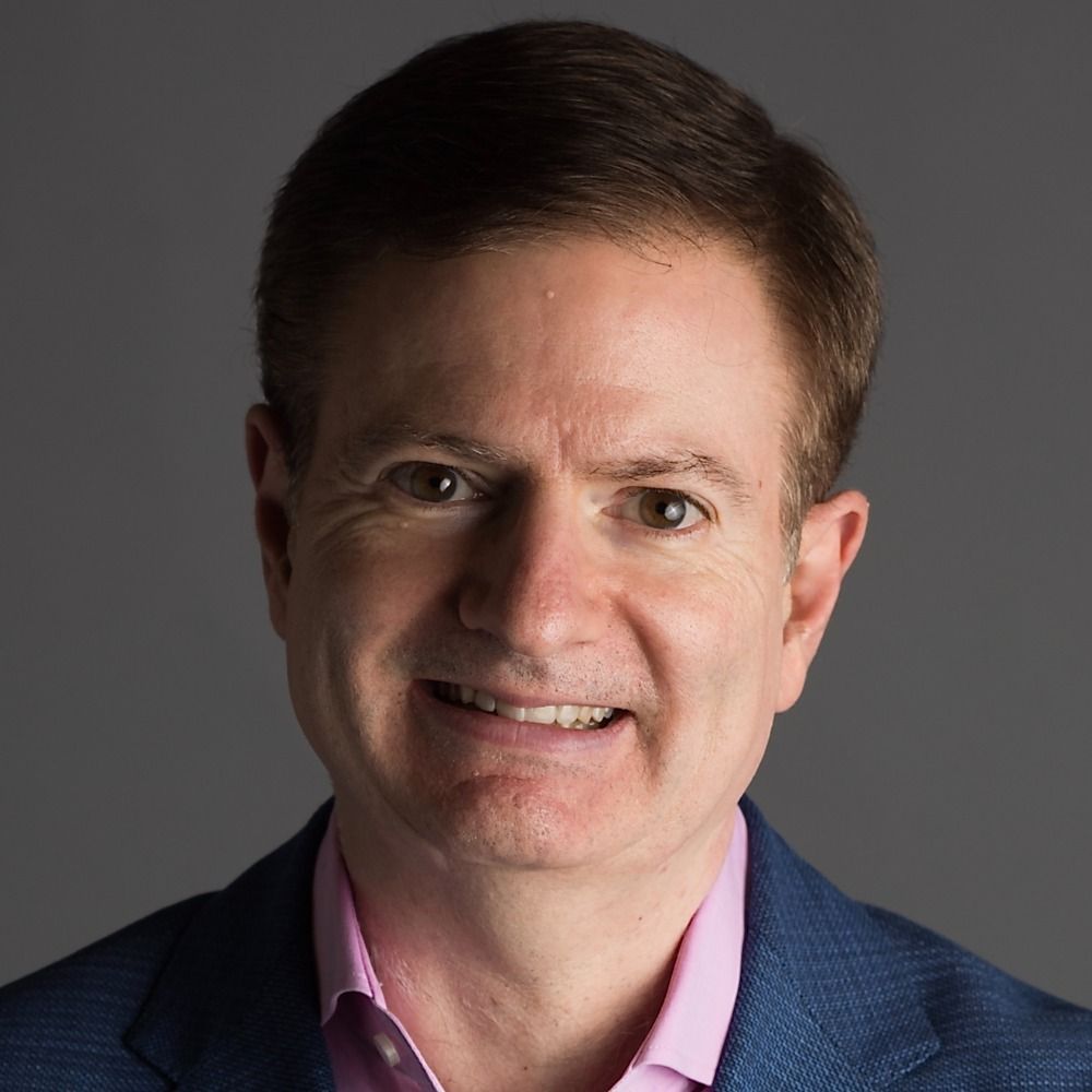 Glenn Kessler's profile picture. His smile doesn't look very happy, almost more of a grimace, as if photo Glenn is aware of what current Glenn is posting and how embarrassing it is.