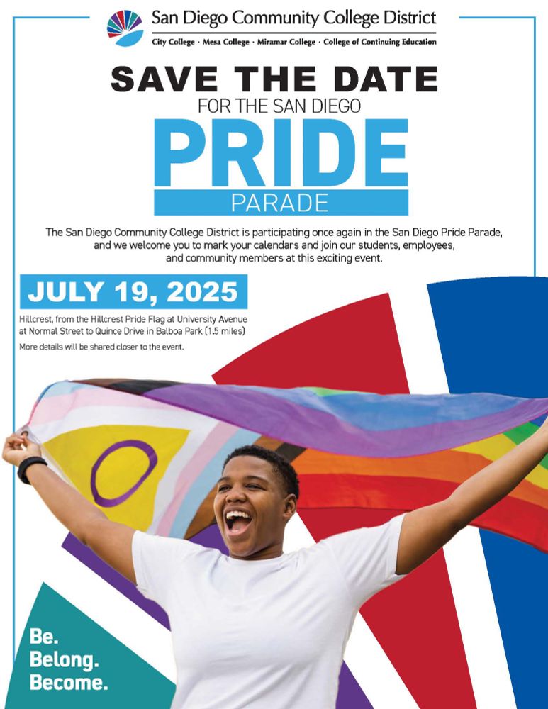 A person wearing a white tee shirt holding the inclusive pride flag over their head.