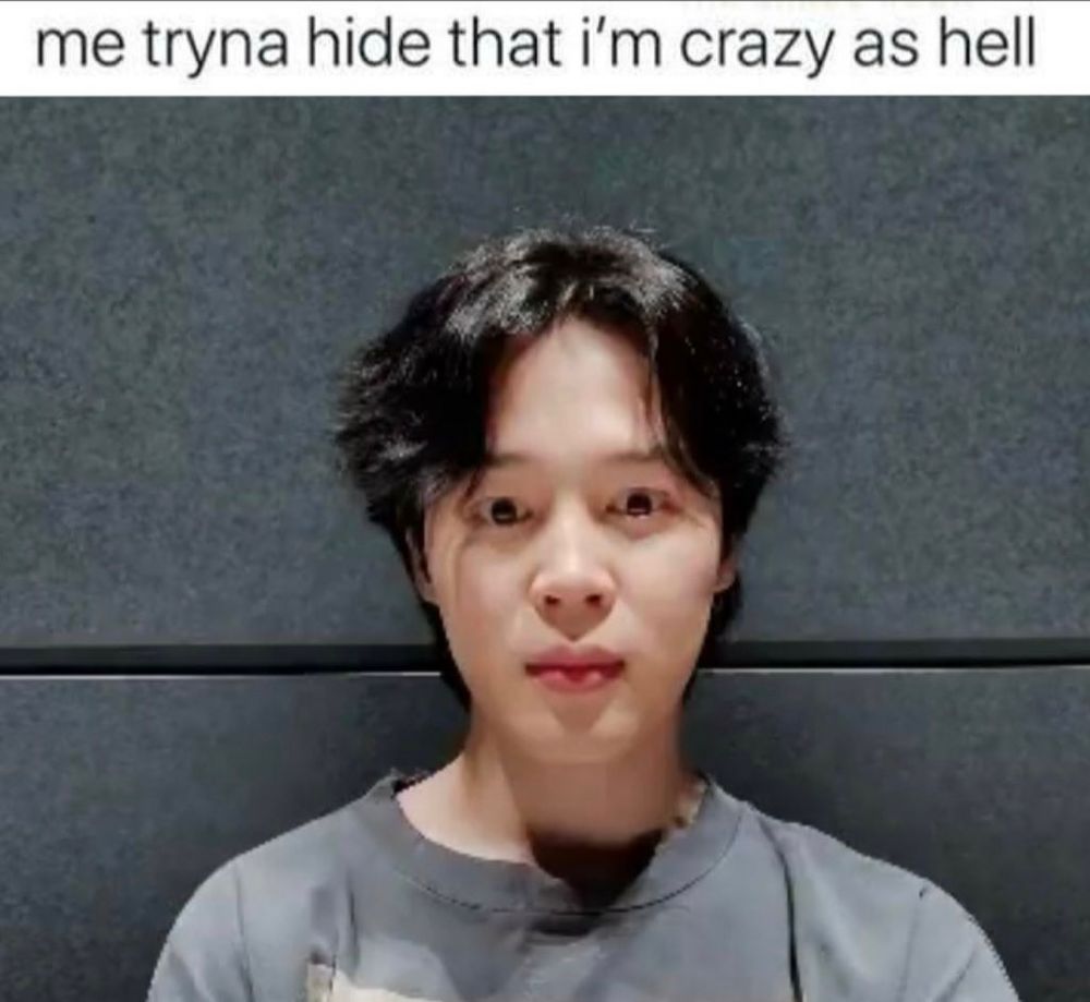 A photo of Jimin staring into the camera with the caption "me tryna hide that I'm crazy as hell"