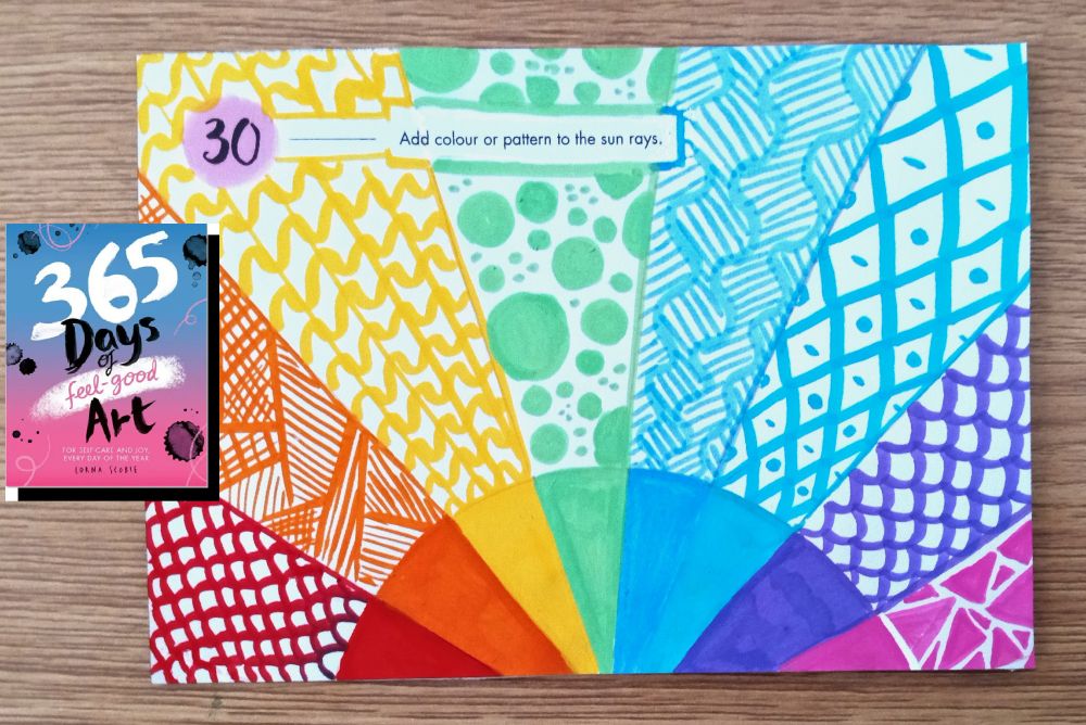 A page of the book "365 Days of Feel-Good Art" completed with bright colors Arrtx acrylic markers and black pen. Prompt 30: Add colour or pattern to the sun rays.
