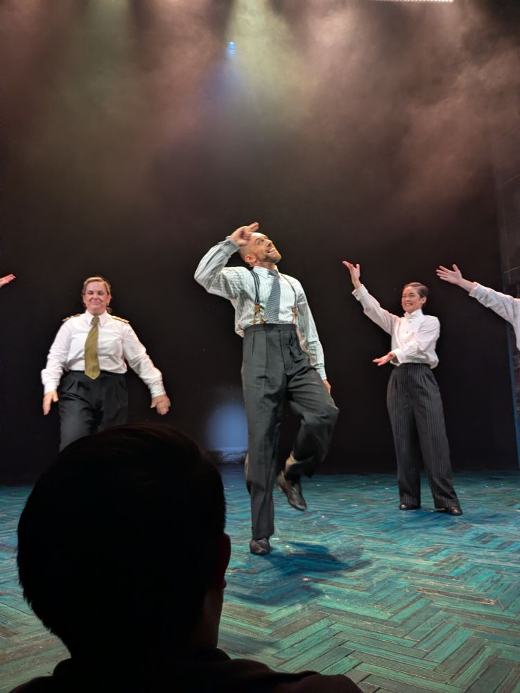Actor David Cumming doing a jaunty salute during the curtain call for Operation Mincemeat