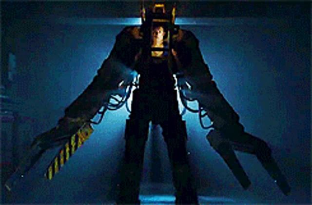 a man is standing in a robotic suit with a ladder attached to his back