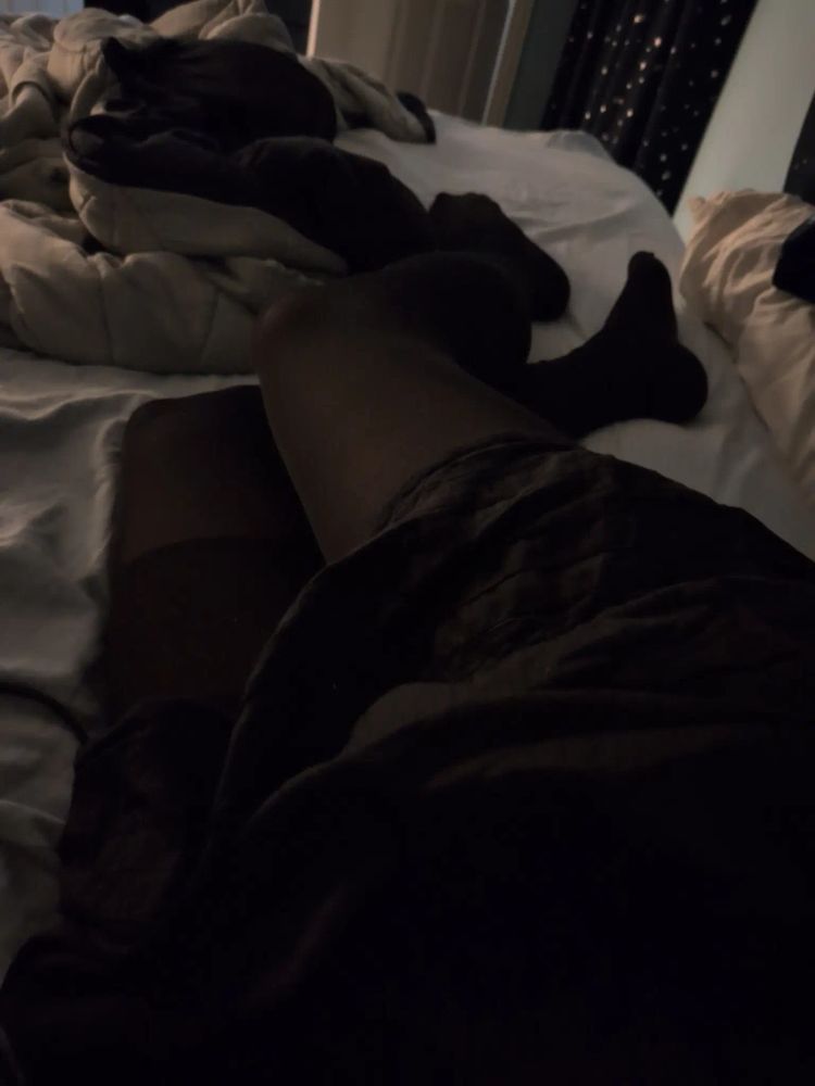 me in stockings i got from cvs and a skirt, lying in an unmade bed
