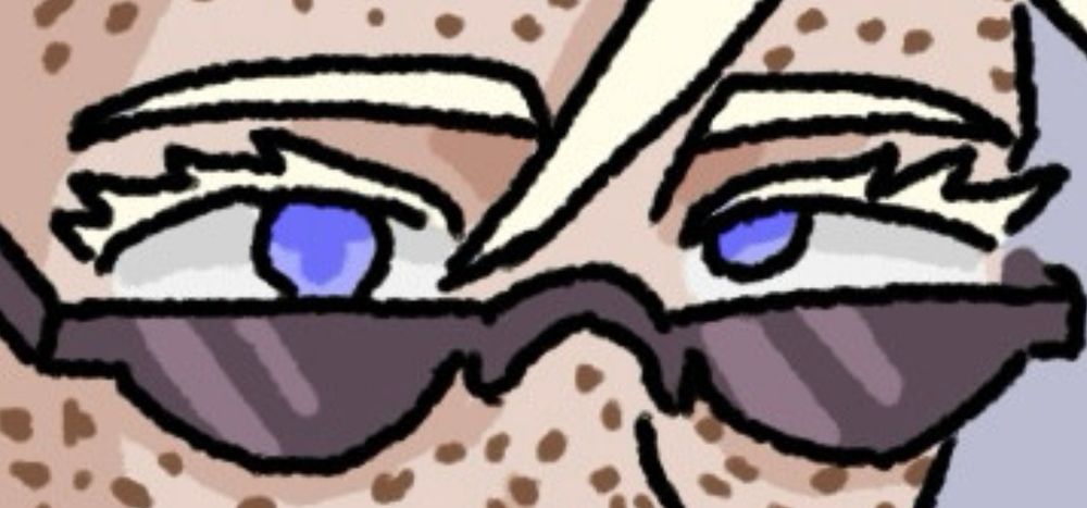 Anahera’s eyes. She has pale blue irises, one of which are misaligned, naturally white eyelashes (all are the result of albinism), and dark sunglasses 