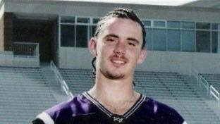 Mike Norvell's college photo wearing a purple jersey and corn rows in an empty stadium