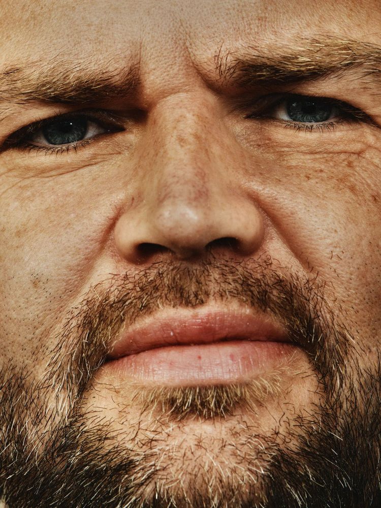 An extreme close-up of JD Vance's face, tightly cropped to show only his eyes, nose, and bearded mouth. The lighting emphasizes the texture of his skin and facial hair.