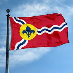 Photo of the St. Louis, MO, flag proudly flying atop a flagpole.