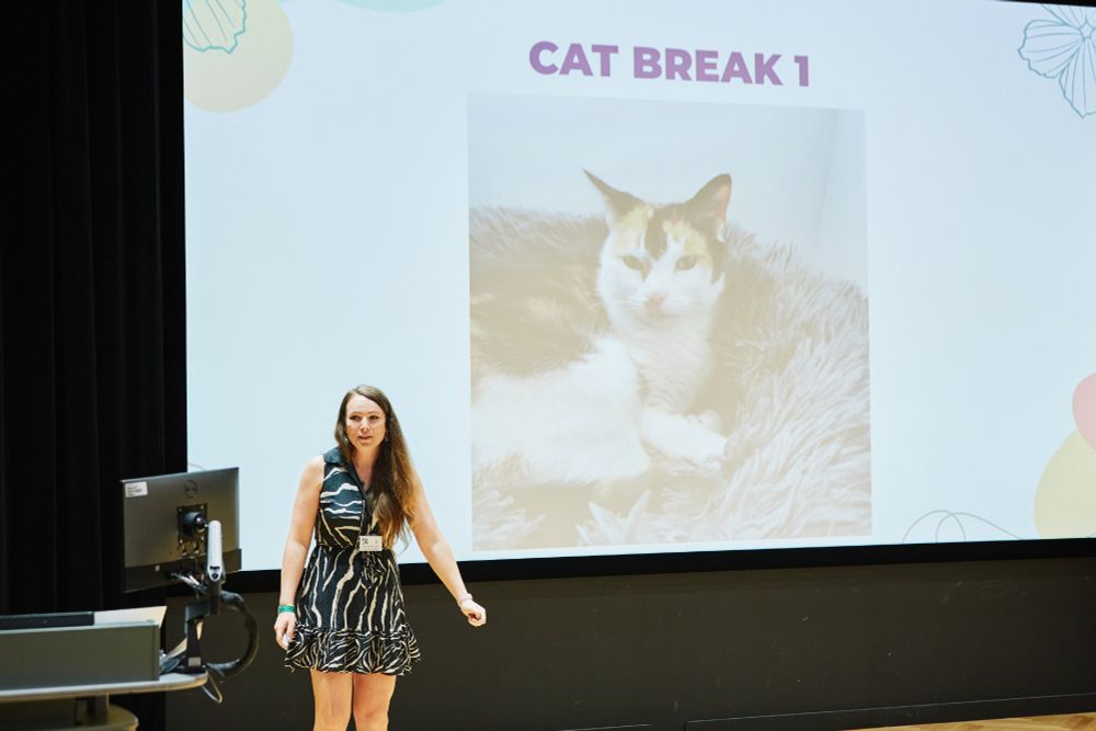 I'm wearing a zebra pattern dress. The slide on the screen has a picture of Poppy my cat on it. The title is Cat Break 1