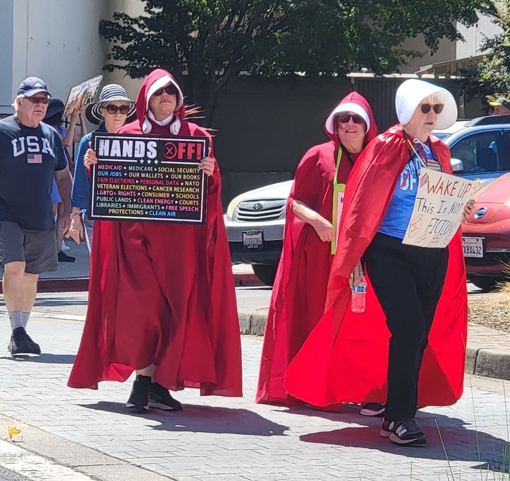 Ladies dressed as the Handmaid's Tale characters at the Workers Over Billionaires Labor Day protest in Walnut Creek, CA, 9/1/25