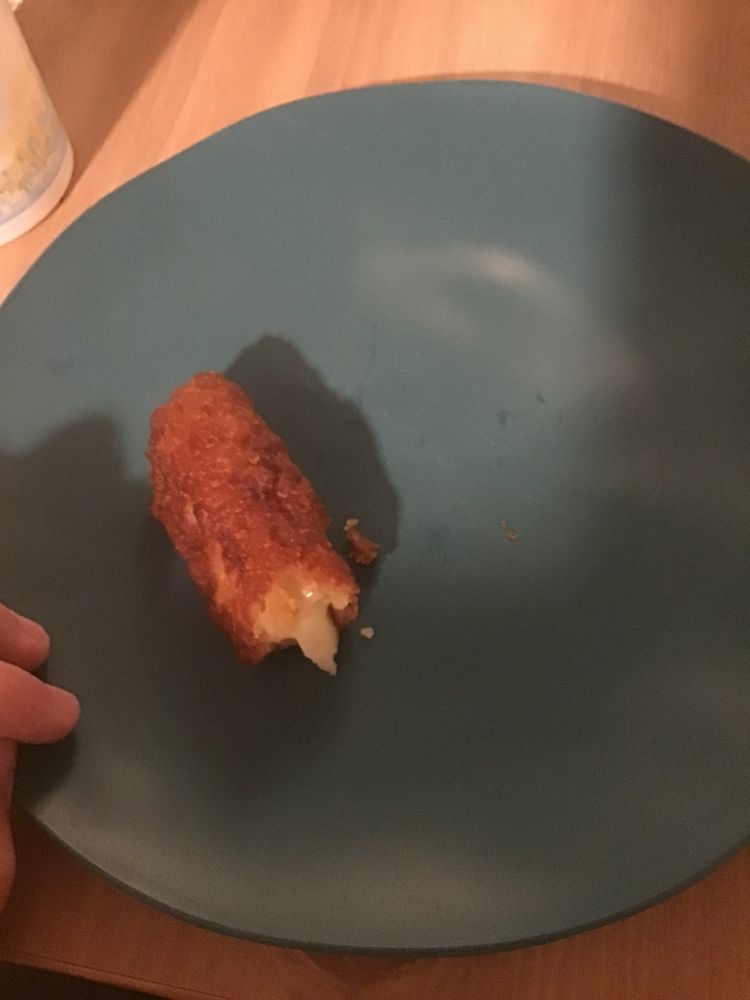 the same mozzerella stick from before, this time it has been biten into once.