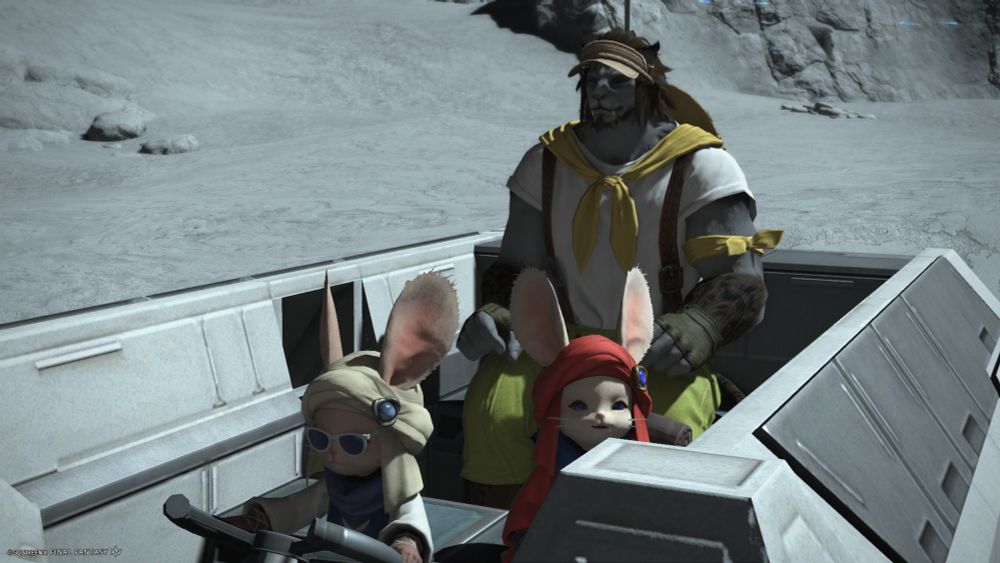 A screenshot from Final Fantasy 14 of my character Exirand sitting in the back of a lunar rover headed to Sinus Ardorum. The vehicle driven by the loporrit Drivingway, with another loporrit, Namingway, behind him on the right. Drivingway is wearing white sunglasses and Exirand is wearing the same outfit as in the previous screenshot (we can see that he is wearing short green trousers and that he has a smaller yellow scarf tied around his left arm). He is smiling and his eyes are closed. The background is composed of the white surface of the moon.