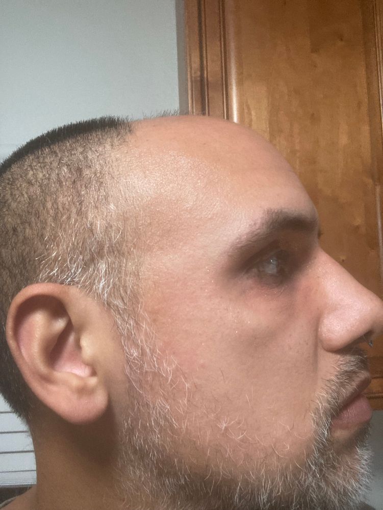 Human with red and sparklier eyeshadow from a different angle 