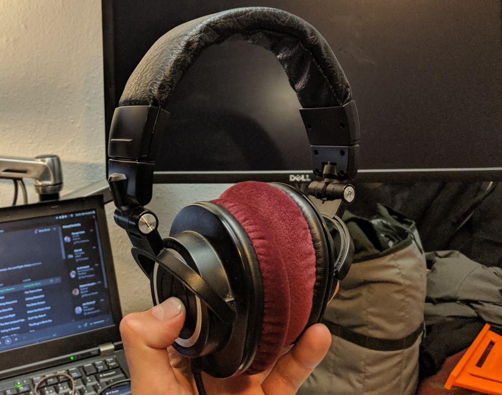 8+ year old (I forget how old here) ATH-M50 headphones with soft maroon velour ear cups, and replaced faux leather with real leather on the headband. 