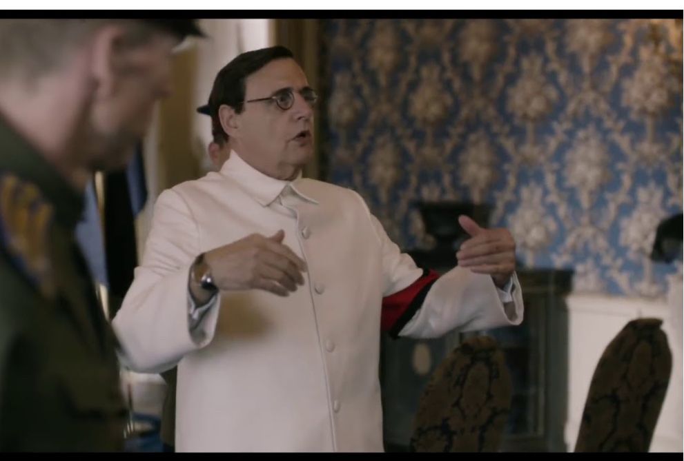 Malenkov (white man in glasses and white suit) in the “no, problem” scene in “the Death of Stalin”